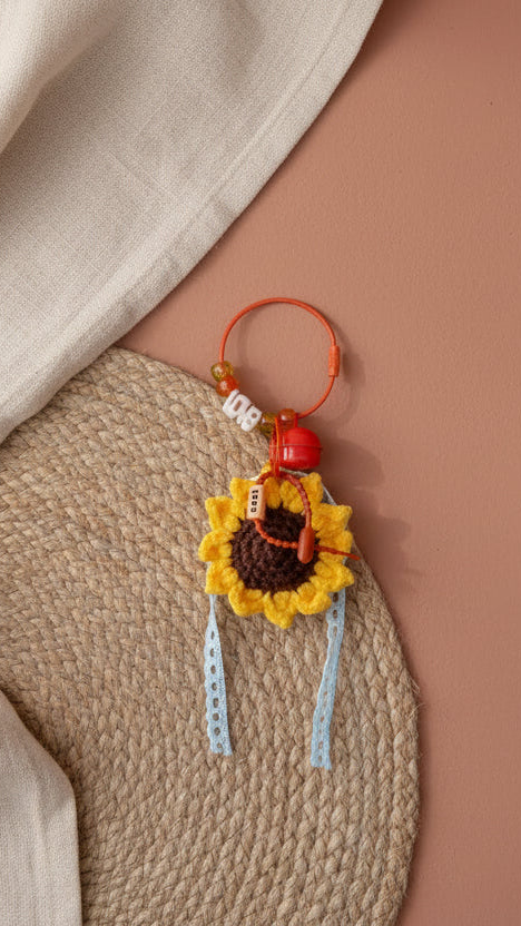 Bijou de sac Soleil d'Or tournesol artisanal en perles avec pompons et anneau doré